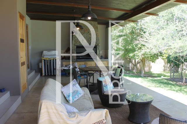 The outdoor braai area with a beautiful garden view..